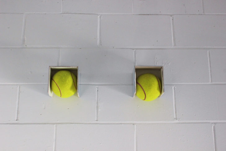 <i>Balls</i> 2010, Oversized tennis balls, tiles, silicon, 2010. 19 x 62 x 15 cm