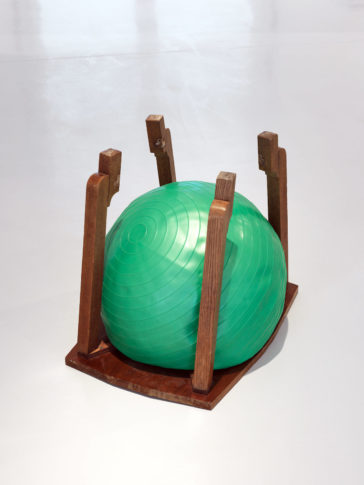 <i>In Shape In Control </i>2009. Wooden table, half deflated/inflated rubber-ball 94 x 62 x 52 cm